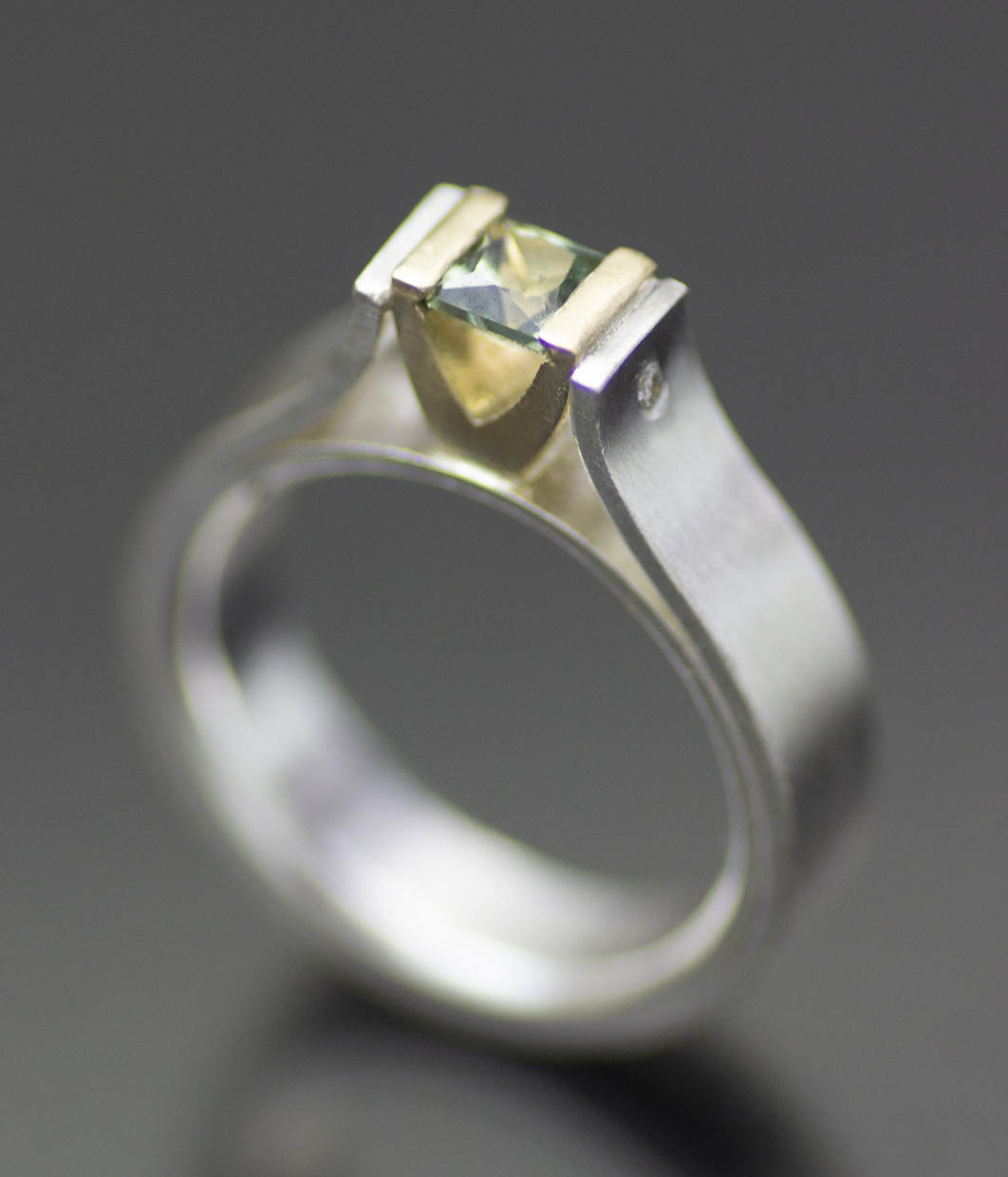 Lolide Seattle USA is a lesbian, gay, queer LGBTQIA+ wedding and engagement jeweler crafting this green sapphire canyon ring