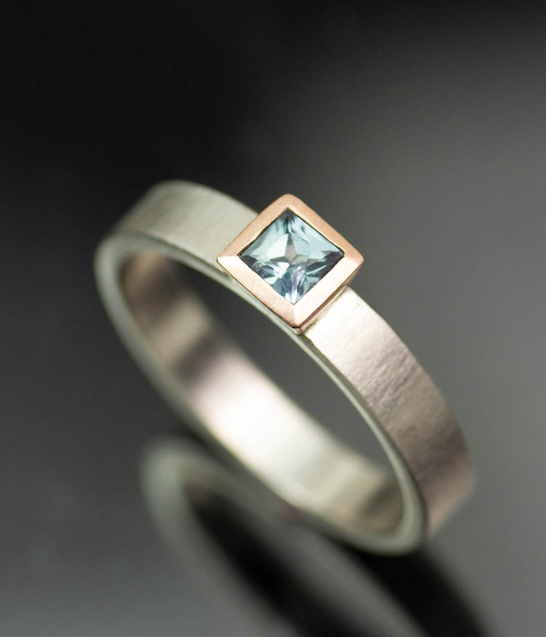 Lolide Seattle USA is a lesbian, gay, queer LGBTQIA+ wedding and engagement jeweler crafting this princess square teal sapphire rose gold ring