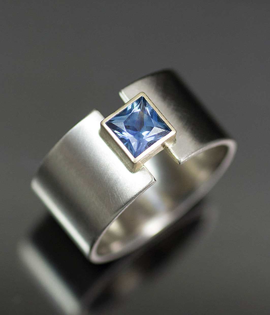 Lolide Seattle USA is a lesbian, gay, queer LGBTQIA+ wedding and engagement jeweler crafting this square lunar eclipse montana sapphire ring