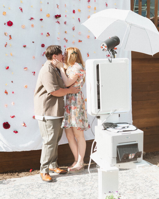"It felt like the last scene of a 90s romance movie. Except this time, I get to keep the girl."⁠
⁠
Cate (she/they) and Laura (she/her) have a tradition: they stop at every photo booth they see. It started on their very first date (after an aquarium trip involving a dozen red roses!), so naturally, Laura knew exactly how to propose.⁠
⁠
The setup? A "garden party" at their best friends' house in Denver to help "promote a new photo booth setup.". Cate stepped in, the camera flashed three times, and when the strip printed... it didn't show their faces.⁠
⁠
It showed photos Laura had taken earlier, holding signs that read: Will. You. Marry. Me. 😭😭😭⁠
⁠
When Cate turned around, Laura was on one knee. Friends popped out (some flew in just for this!), and the backyard turned into a full-blown celebration.⁠
⁠
We’ve just popped this full story online for you to obsess over - find it at the link up in our bio! 👆⁠
⁠
Featured in @dancingwithher⁠
Photography by @kateivyphotography⁠
Lovers @catehairmakeup & @raaberwocky