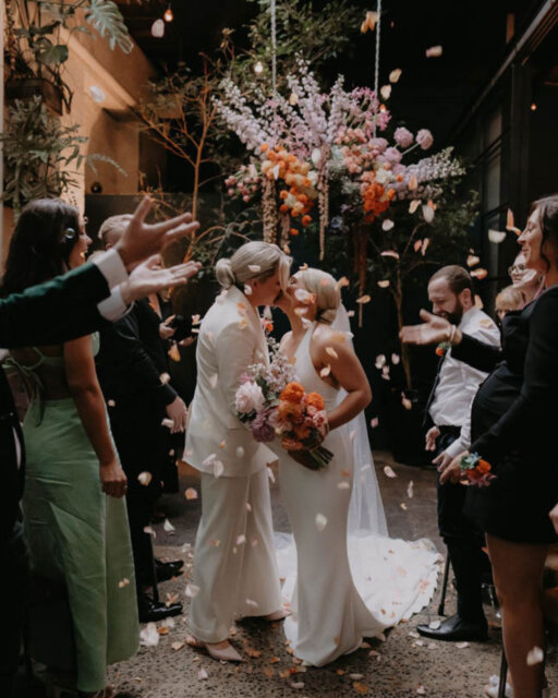 Melbourne based, travels Australia-wide, and very clear on one thing: you do not need to be 'good at photos.' 90% of @lovebombphotos' couples say they’re awkward on camera. 100% of them are wrong.⁠
⁠
She’ll tell terrible jokes. She’ll hype you up. She’ll know when to step back and let the moment breathe. She’s not here to fix your dress into a perfect circle or stop the wind from messing up your hair. She’s not going to tell you to “pretend laugh” or “just fake a kiss.” ⁠
⁠
There’s a real party energy to Hailey's work, but it’s still romantic. Intimate. Warm.⁠
⁠
She’s also the type who’ll help you plan, recommend vendors, encourage the champagne, and then stay up late editing with strong coffee and two kids asleep down the hall, so that you're day is *incredible*.⁠
⁠
You'll find @lovebombphotos up over in our online directory of inclusive wedding vendors - linked up there, always 👆